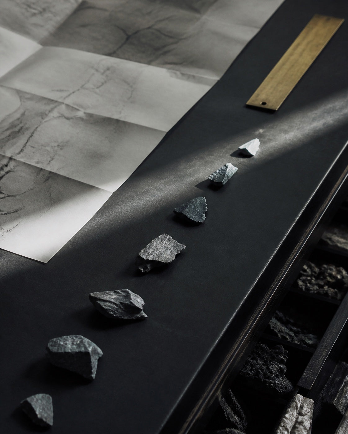 Angular mineral fragments arranged along a diagonal path for The River chapter.