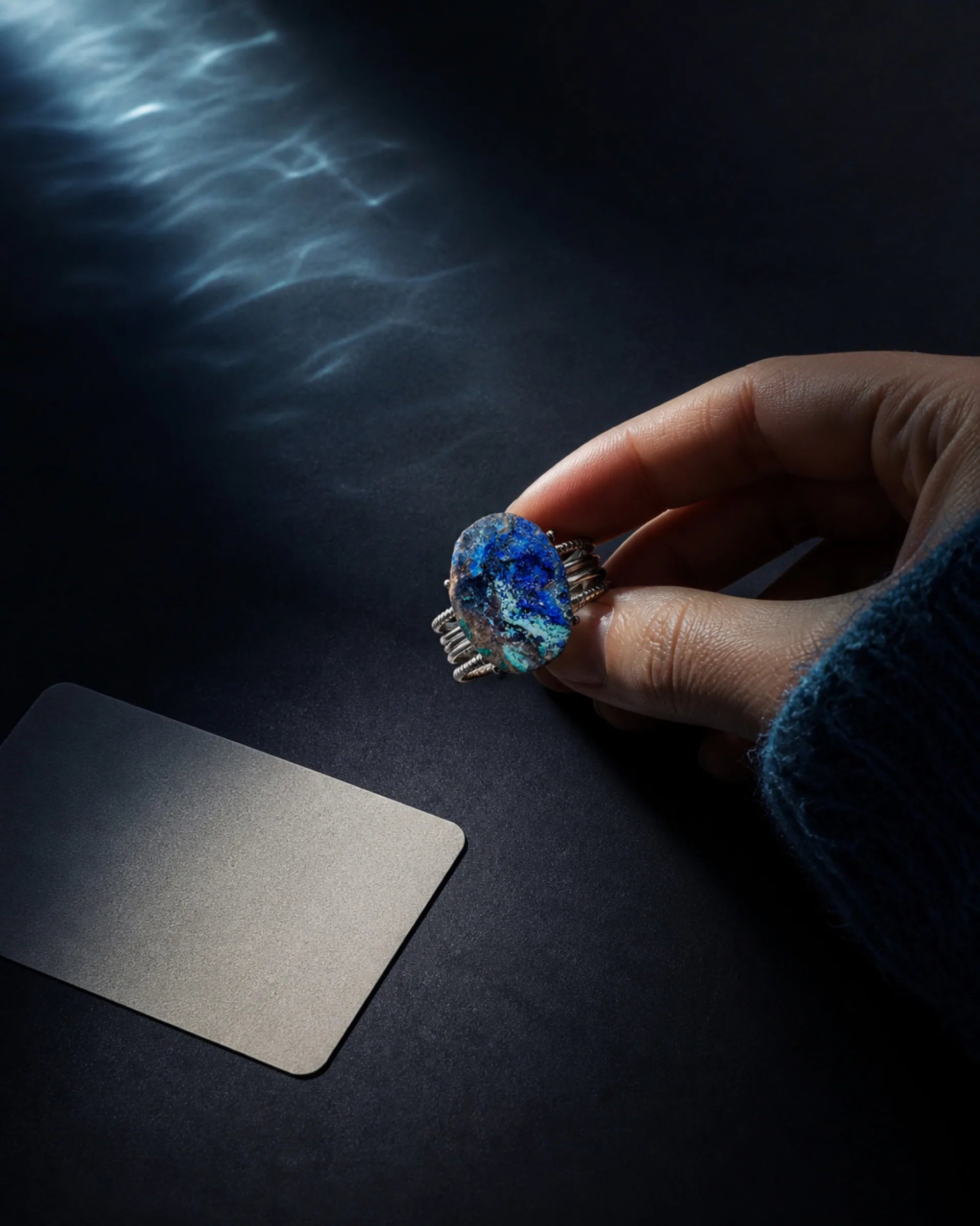 A departure scene with a blue mineral piece for The River chapter.