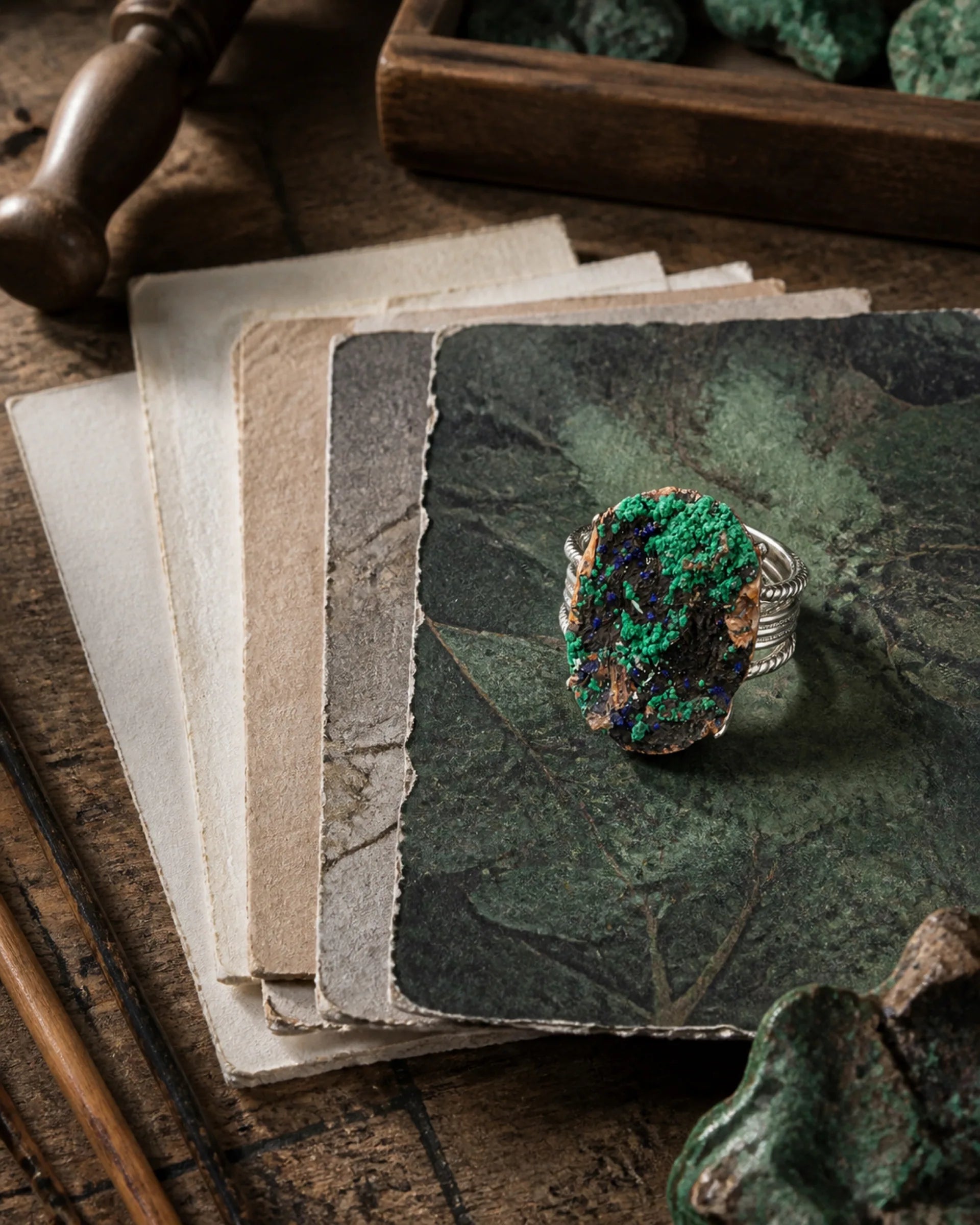 A working table and green mineral piece for The Grove chapter.